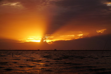 Dramatic dark cloudscape passing, fast flying, rolling bright sunset sky, beautiful nature landscape of day to night in 4K.