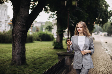 Young businesswoman walking down the lane in a rainy weather