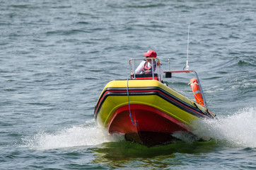 Fototapeta premium LIFEBOAT - The rescuer patrols the holiday bathing resort on the sea coast
