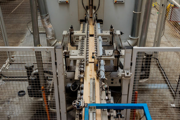 Production line of the wooden floor factory. CNC automatic woodworking machine.