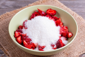 Slices of strawberries with sugar in a bowl
