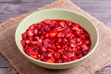 Slices of strawberries with sugar in a bowl