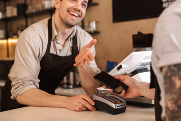 Close up of a customer paying at the coffee shop counter