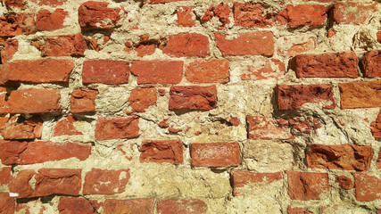 Background wall of red old broken brick.