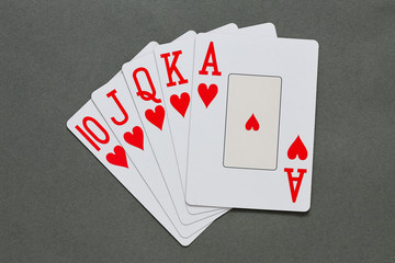 A royal straight flush playing cards poker hand in hearts.