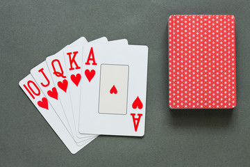 A royal straight flush playing cards poker hand in hearts.