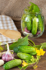 pickled cucumbers on a wooden background