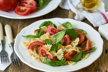 Farfalle pasta salad with tomatoes and green basil