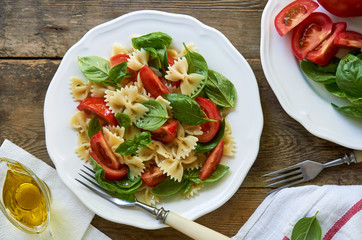 Farfalle pasta salad with tomatoes and green basil