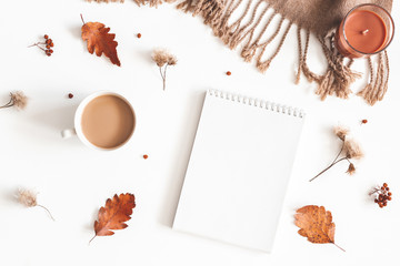 Autumn composition. Cup of coffee, plaid, notepad, autumn leaves on white background. Flat lay, top view, copy space