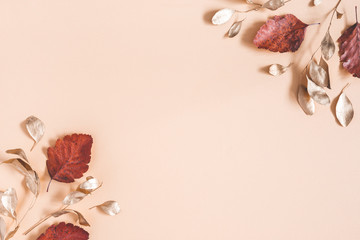 Autumn composition. Golden eucalyptus leaves on beige background. Autumn, fall concept. Flat lay,...