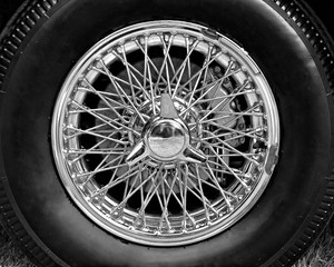 Closeup of vintage car wire wheel in black and white - Powered by Adobe