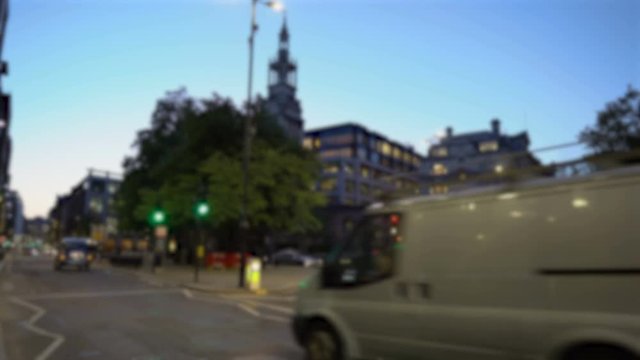 Blurry Light Traffic in London, UK With Cars, Double Decker Bus and Taxi Cab During Evening