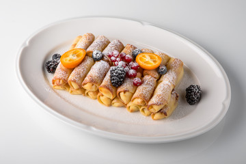 Dessert. Sweet pancakes with jam, caramel, fruit and berries. Banquet festive dishes. Fine dining restaurant menu. White background. 