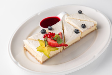 Dessert. Delicious cheesecake with berries. Banquet festive dishes. Fine dining restaurant menu. White background. 