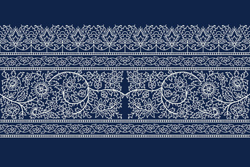 Woodblock printed indigo dye seamless floral ethnic border. Traditional oriental ornament of India, flower garland motif, ecru on navy blue background. Textile design.