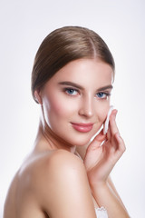 Fototapeta premium Beautiful young smiling woman with clean cotton pads . Beauty skin care famale face