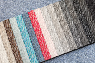 Multi-colored samples of upholstery fabric for sofas and chairs close-up.