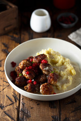 Meatballs with potato and red berries