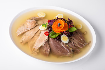 Broth jelly with meat and vegetables. Banquet festive dishes. Gourmet restaurant menu. White background.