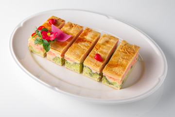 Quiche, casserole, delicious omelet from eggs, cheese, salmon, broccoli, spinach, pate. Banquet festive dishes. Gourmet restaurant menu. White background.
