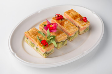 Quiche, casserole, delicious omelet from eggs, cheese, salmon, broccoli, spinach, pate. Banquet festive dishes. Gourmet restaurant menu. White background.