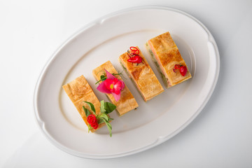 Quiche, casserole, delicious omelet from eggs, cheese, salmon, broccoli, spinach, pate. Banquet festive dishes. Gourmet restaurant menu. White background.