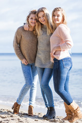 Three fashionable sister on the beach