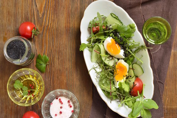 Cucumber, tomato, egg, fresh green salad with black sesame, top view, copy space