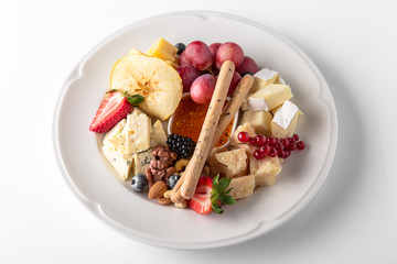 Luxurious cheese plate of different types of cheese: camembert, dorblu, parmesan, cheddar, with...