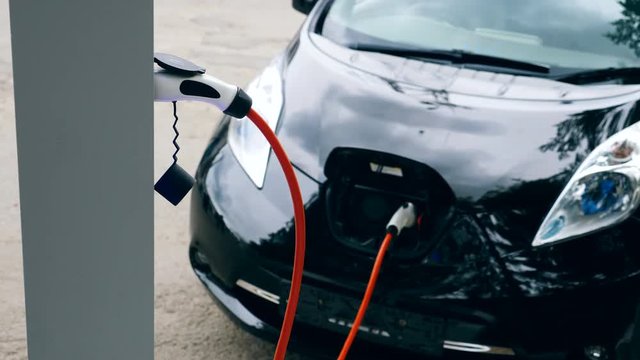 Electrocar is being refueled with electricity