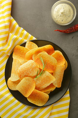 Crispy potato chips with delicious sauce. Top view. Copy space.