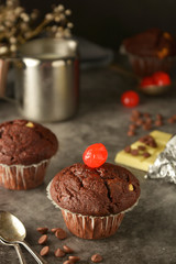 Chocolate muffins on dark background. Milk and chocolate.