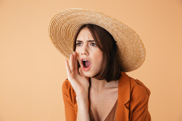 Beautiful young woman wearing straw hat