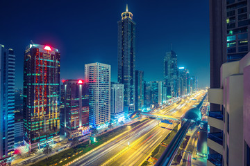 Downtown Dubai at night. Scenic aerial view on highways and skyscrapers.