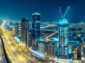 Obraz premium Downtown Dubai at night. Scenic aerial view on highways and skyscrapers.