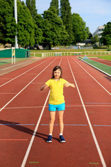 Obraz premium Little girl have fun on the stadium