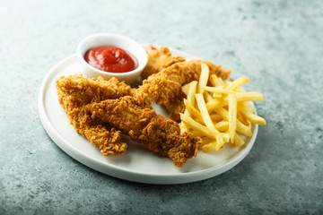 Homemade fish and chips on white plate