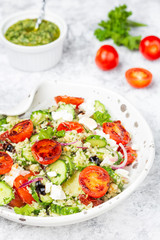 mediterranean couscous salad with fried cherry tomatoes, cucumber