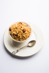 Traditional Jaggery Rice or Gur wale chawal in Hindi, served in a bowl with spoon. selective focus
