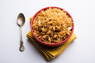 Traditional Jaggery Rice or Gur wale chawal in Hindi, served in a bowl with spoon. selective focus
