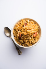 Traditional Jaggery Rice or Gur wale chawal in Hindi, served in a bowl with spoon. selective focus