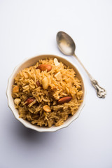 Traditional Jaggery Rice or Gur wale chawal in Hindi, served in a bowl with spoon. selective focus