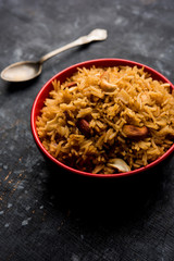 Traditional Jaggery Rice or Gur wale chawal in Hindi, served in a bowl with spoon. selective focus