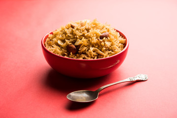 Traditional Jaggery Rice or Gur wale chawal in Hindi, served in a bowl with spoon. selective focus