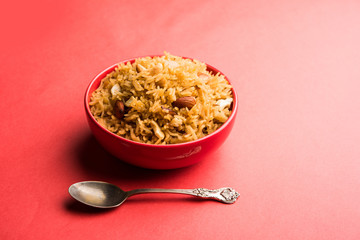 Traditional Jaggery Rice or Gur wale chawal in Hindi, served in a bowl with spoon. selective focus