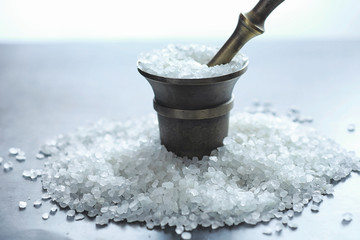 Large sea salt. Spice. Mortar and pestle for grinding.