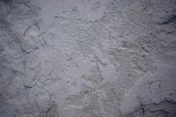 Old grey uneven stucco surface. Background texture. 