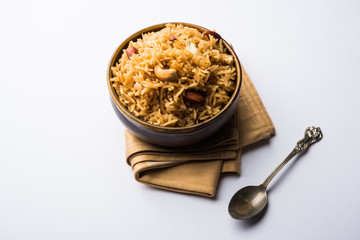 Traditional Jaggery Rice or Gur wale chawal in Hindi, served in a bowl with spoon. selective focus