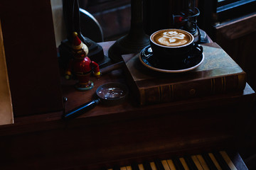 Art latte a cup of hot coffee on Piano